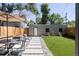 Cozy backyard featuring an outdoor dining area, artificial grass, and a detached garage at 142 N Logan St, Denver, CO 80203