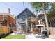 Charming backyard with a hammock, wooden deck, and a small dining set for outdoor enjoyment at 142 N Logan St, Denver, CO 80203