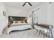 Bright bedroom features a dark headboard and desk by window with curtains at 142 N Logan St, Denver, CO 80203