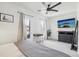 Light-filled bedroom features two windows, gray bedding, a wall-mounted TV, and furnishings at 142 N Logan St, Denver, CO 80203