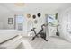 A bedroom featuring an exercise bike, a hat collection, white walls, and natural light at 142 N Logan St, Denver, CO 80203