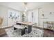 Bright and airy dining room showcasing large dining table, windows, and modern lighting at 142 N Logan St, Denver, CO 80203
