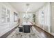Light-filled dining room boasts modern lighting, large dining table, and neutral paint at 142 N Logan St, Denver, CO 80203