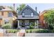 Inviting front of home with well-manicured lawn, iron fence, and classic architectural details at 142 N Logan St, Denver, CO 80203