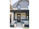 Covered front porch with brick pillars and lanterns on either side of the entrance steps at 142 N Logan St, Denver, CO 80203
