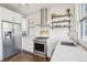 This spacious kitchen features stainless steel appliances, white cabinets, and wood floors at 142 N Logan St, Denver, CO 80203