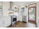 The kitchen boasts stainless steel appliances, white cabinets, and butcher block countertop at 142 N Logan St, Denver, CO 80203