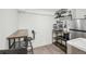 A compact kitchenette with a butcher block countertop and shelving for storage at 142 N Logan St, Denver, CO 80203