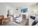 Bright living room boasts fireplace, hardwood floors, neutral paint, and open dining room at 142 N Logan St, Denver, CO 80203
