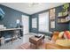 Cozy living room with dark teal walls, a brown sofa, and a modern coffee table at 142 N Logan St, Denver, CO 80203