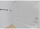 All-white tiled bathtub and shower combination at 5255 Memphis St # 1112, Denver, CO 80239