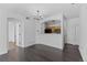 Dining area with dark hardwood floors, modern light fixture, and adjacent open kitchen at 5255 Memphis St # 1112, Denver, CO 80239
