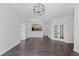 Spacious living room with hardwood floors, modern lighting, and an open view of the kitchen at 5255 Memphis St # 1112, Denver, CO 80239