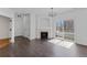 Bright living room featuring dark wood floors, a fireplace, and sliding glass doors to a balcony at 5255 Memphis St # 1112, Denver, CO 80239