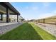 Well-maintained backyard with green grass, rock ground cover, and wooden fencing for privacy and charm at 455 Rogers Way, Castle Rock, CO 80104