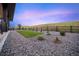 Low-maintenance backyard features xeriscaping and a minimalist fenced yard at 455 Rogers Way, Castle Rock, CO 80104