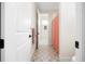 This bright bathroom features custom tile floors, peach bathmat, and is accessible via a white doorway at 455 Rogers Way, Castle Rock, CO 80104