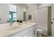 Bright bathroom with dual sinks, white cabinetry, light countertops, and shower with white tiling at 455 Rogers Way, Castle Rock, CO 80104