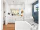 Bright bathroom featuring a soaking tub, walk-in shower, and a large vanity with modern mirrors at 455 Rogers Way, Castle Rock, CO 80104