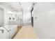 Bright bathroom featuring a soaking tub, walk-in shower, and modern white tile at 455 Rogers Way, Castle Rock, CO 80104