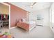 Stylish bedroom features a white bed, adjacent walk-in closet, and dresser at 455 Rogers Way, Castle Rock, CO 80104