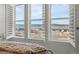 Bedroom view of scenic landscape through large windows with plantation shutters, plush bedding at 455 Rogers Way, Castle Rock, CO 80104