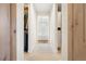 Walk-through closet with custom shelving, hanging rods, and access to a bright bathroom at 455 Rogers Way, Castle Rock, CO 80104