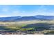 Elevated view shows neighborhood nestled in scenic landscape of rolling hills and distant mountains at 455 Rogers Way, Castle Rock, CO 80104