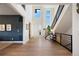 Welcoming foyer with wood floors, an elegant staircase, and tall windows for natural light, enhancing its appeal at 455 Rogers Way, Castle Rock, CO 80104
