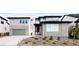 Beautiful home with a stone accents, a two-car garage, modern design, and an immaculate lawn for an inviting appeal at 455 Rogers Way, Castle Rock, CO 80104