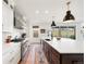 Well-lit kitchen with stainless steel appliances and a center island sink at 455 Rogers Way, Castle Rock, CO 80104
