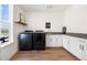 Well-equipped laundry room with modern washer and dryer, ample cabinet space, and a view to the exterior at 455 Rogers Way, Castle Rock, CO 80104