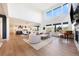 Open-concept living room seamlessly connecting to the kitchen and dining areas, ideal for modern living and entertaining at 455 Rogers Way, Castle Rock, CO 80104