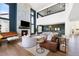 Bright living room with stone fireplace, high ceilings, and lots of natural light at 455 Rogers Way, Castle Rock, CO 80104