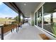 Inviting covered porch with flower boxes, rocking chairs, and large glass windows on a sunny day at 455 Rogers Way, Castle Rock, CO 80104