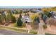 Expansive aerial view of house showcasing surrounding trees and landscaping at 7220 Spring Creek Cir, Niwot, CO 80503