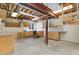 Unfinished basement featuring bright lighting, sink, work benches, and storage cabinets at 7220 Spring Creek Cir, Niwot, CO 80503