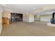 Finished basement featuring carpet floors, wet bar, fireplace, custom shelving, and ample space at 7220 Spring Creek Cir, Niwot, CO 80503