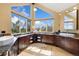 Bright bathroom featuring a vanity with granite countertop, dual sinks, and ample natural light from large windows at 7220 Spring Creek Cir, Niwot, CO 80503