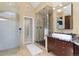 Modern bathroom with glass-enclosed shower, sleek vanity with granite countertop, and tiled flooring at 7220 Spring Creek Cir, Niwot, CO 80503