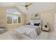 Comfortable bedroom featuring vaulted ceiling, plantation shutters, ceiling fan, and neutral color scheme at 7220 Spring Creek Cir, Niwot, CO 80503