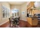 Cozy dining area adjacent to kitchen, with hardwood floors and bright natural light from the windows at 7220 Spring Creek Cir, Niwot, CO 80503
