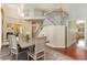 Open floorplan dining area featuring soaring ceilings, a stylish chandelier, and staircase at 7220 Spring Creek Cir, Niwot, CO 80503