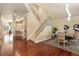 Elegant foyer featuring gleaming hardwood floors, a staircase with metal railing, and sophisticated decor at 7220 Spring Creek Cir, Niwot, CO 80503