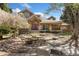 Charming home featuring a stone facade, covered porch with wooden beams, and beautiful landscaping with mature trees at 7220 Spring Creek Cir, Niwot, CO 80503