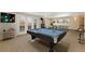 Spacious game room featuring a pool table, fireplace, ping pong table, and ample natural light at 7220 Spring Creek Cir, Niwot, CO 80503