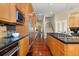 Long gourmet kitchen featuring a large island, black countertops, and stainless steel appliances at 7220 Spring Creek Cir, Niwot, CO 80503