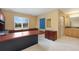 A home office area, featuring carpet floors, warm colors, a large desk, and natural light at 7220 Spring Creek Cir, Niwot, CO 80503