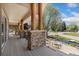 Spacious covered porch featuring stone pillar bases and wood columns at 7220 Spring Creek Cir, Niwot, CO 80503