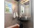 Unique powder room with designer sink and fixtures, modern paint, and hardwood floors at 7220 Spring Creek Cir, Niwot, CO 80503